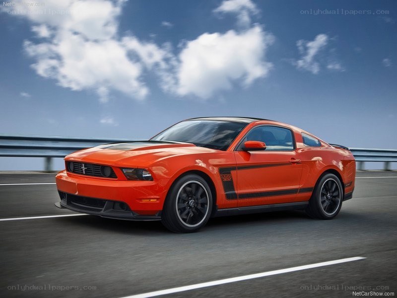 Orange Ford Mustang on highway