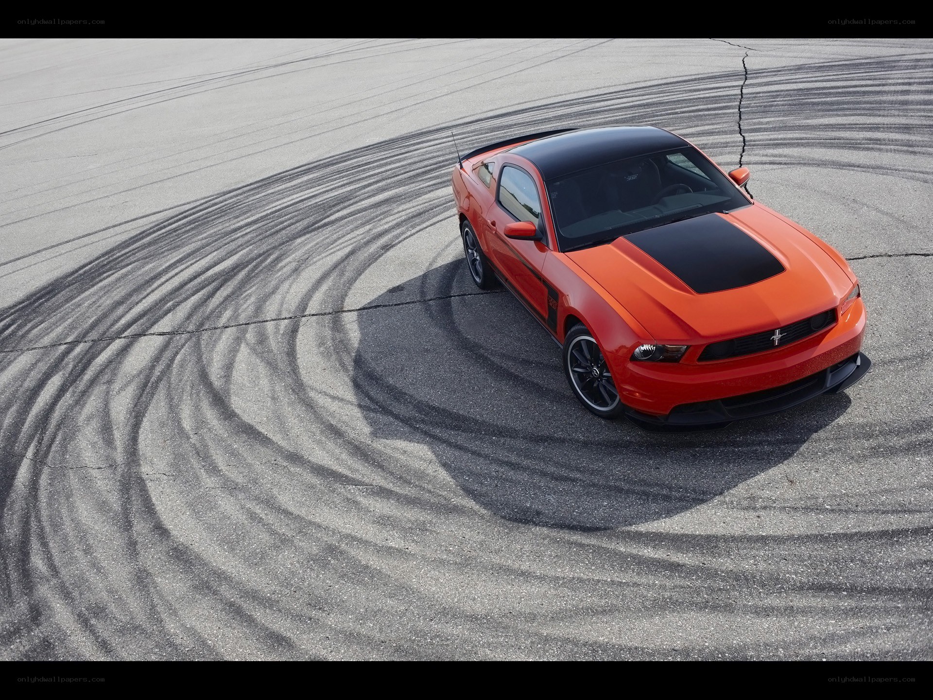 Orange Ford Mustang on racetrack