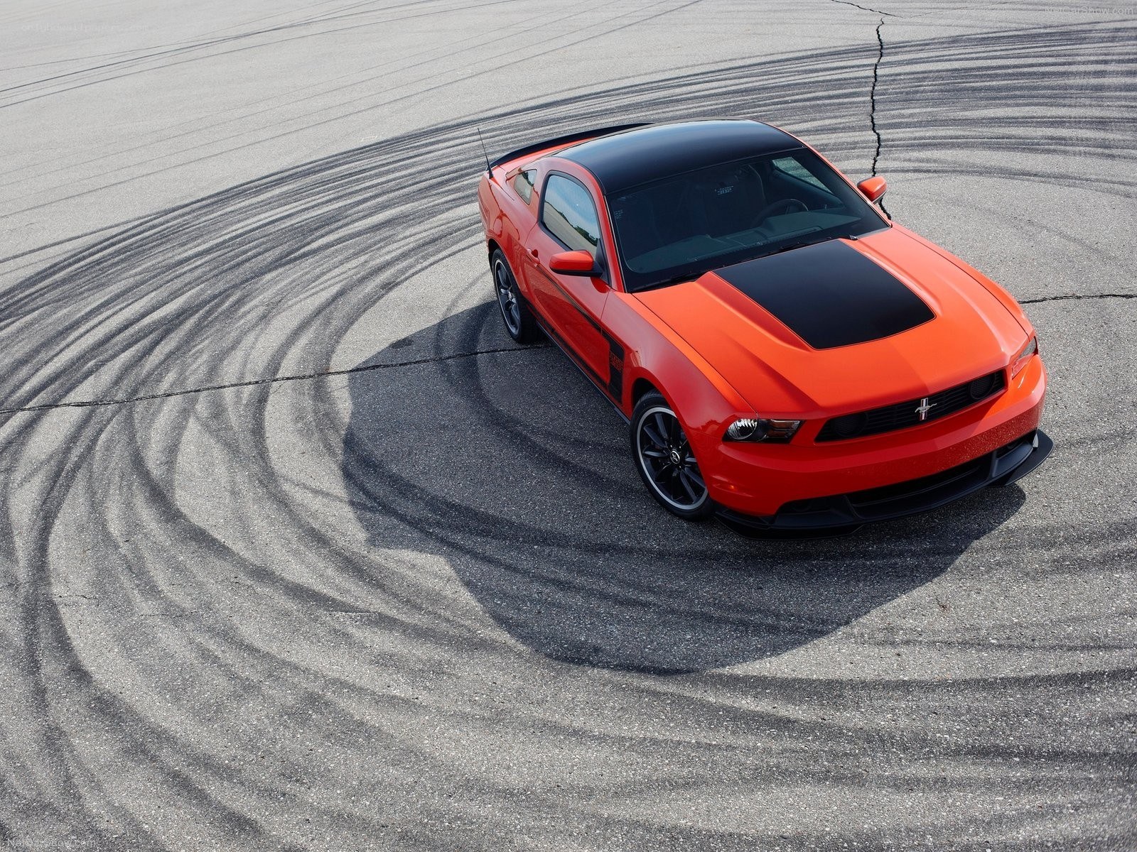 Orange Ford Mustang on track