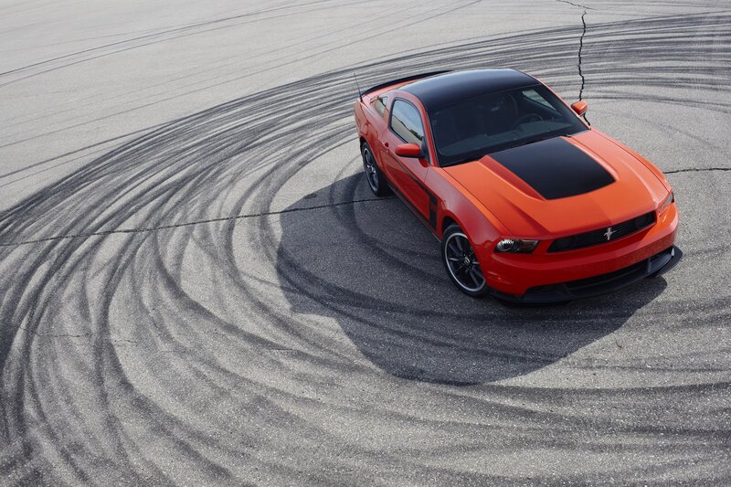 Orange Ford Mustang on track