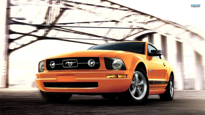 Orange Ford Mustang under bridge