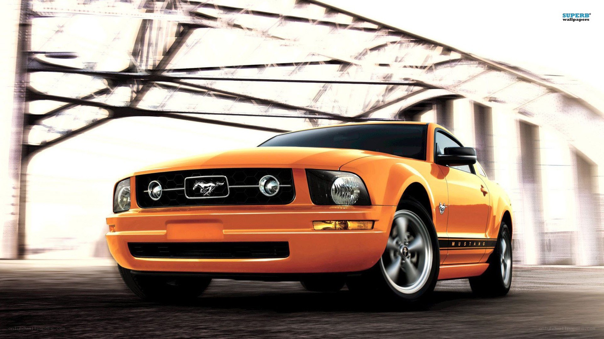Orange Ford Mustang under bridge