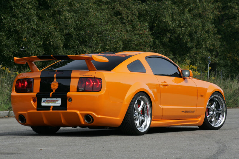 orange ford mustang with rear spoiler