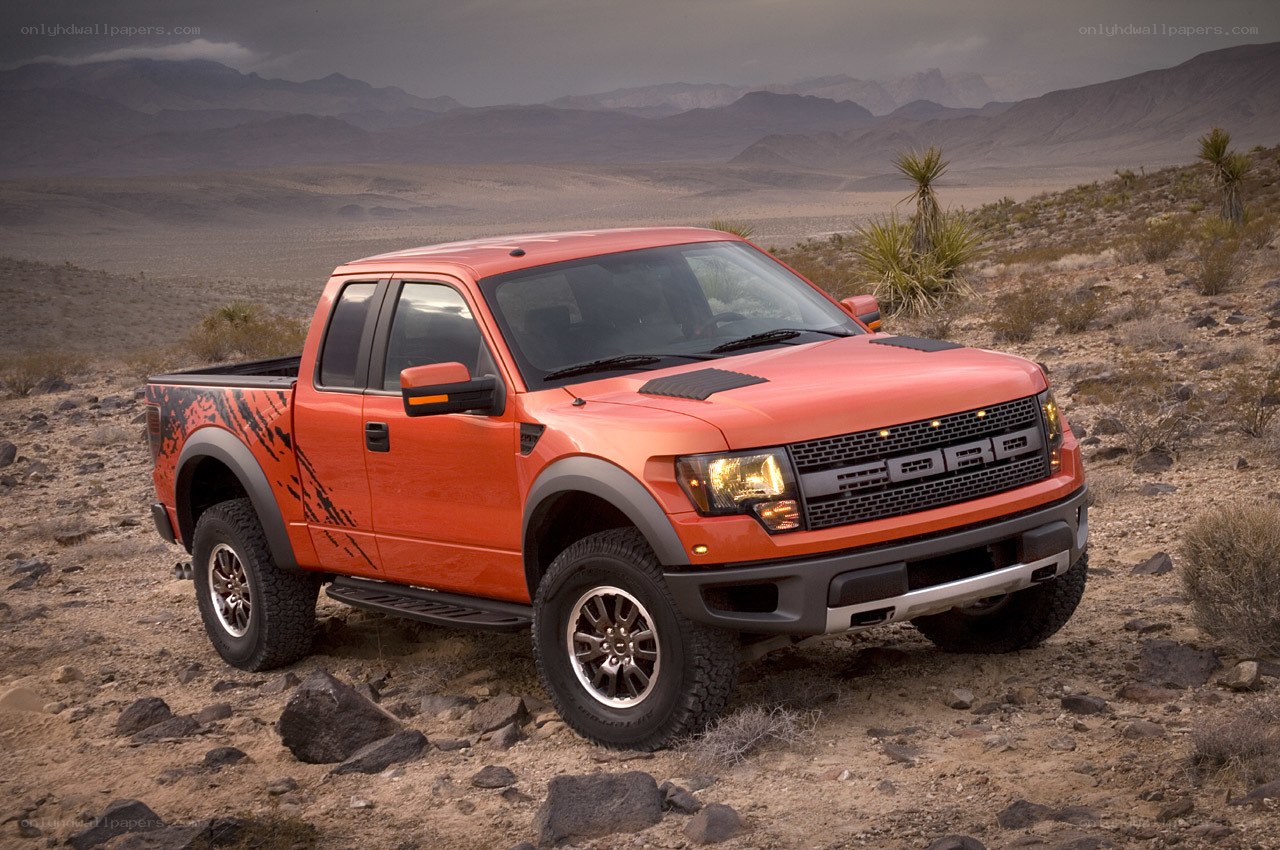 Orange Ford Raptor in desert