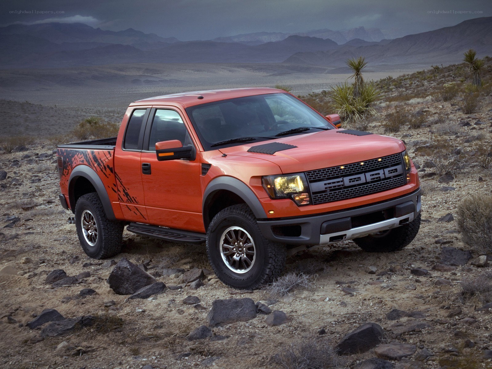 Orange Ford Raptor in desert