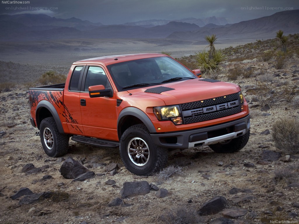 Orange Ford Raptor in desert