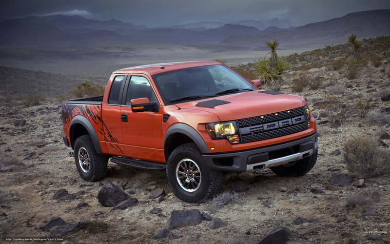 Orange Ford Raptor in desert