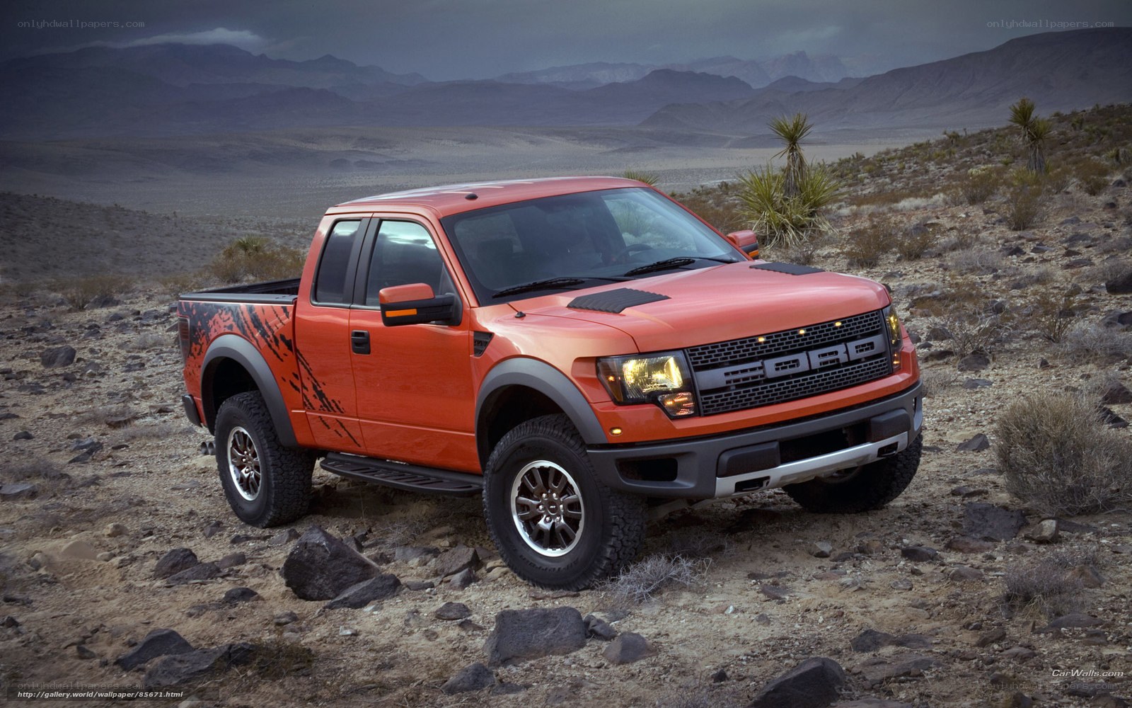 Orange Ford Raptor in desert