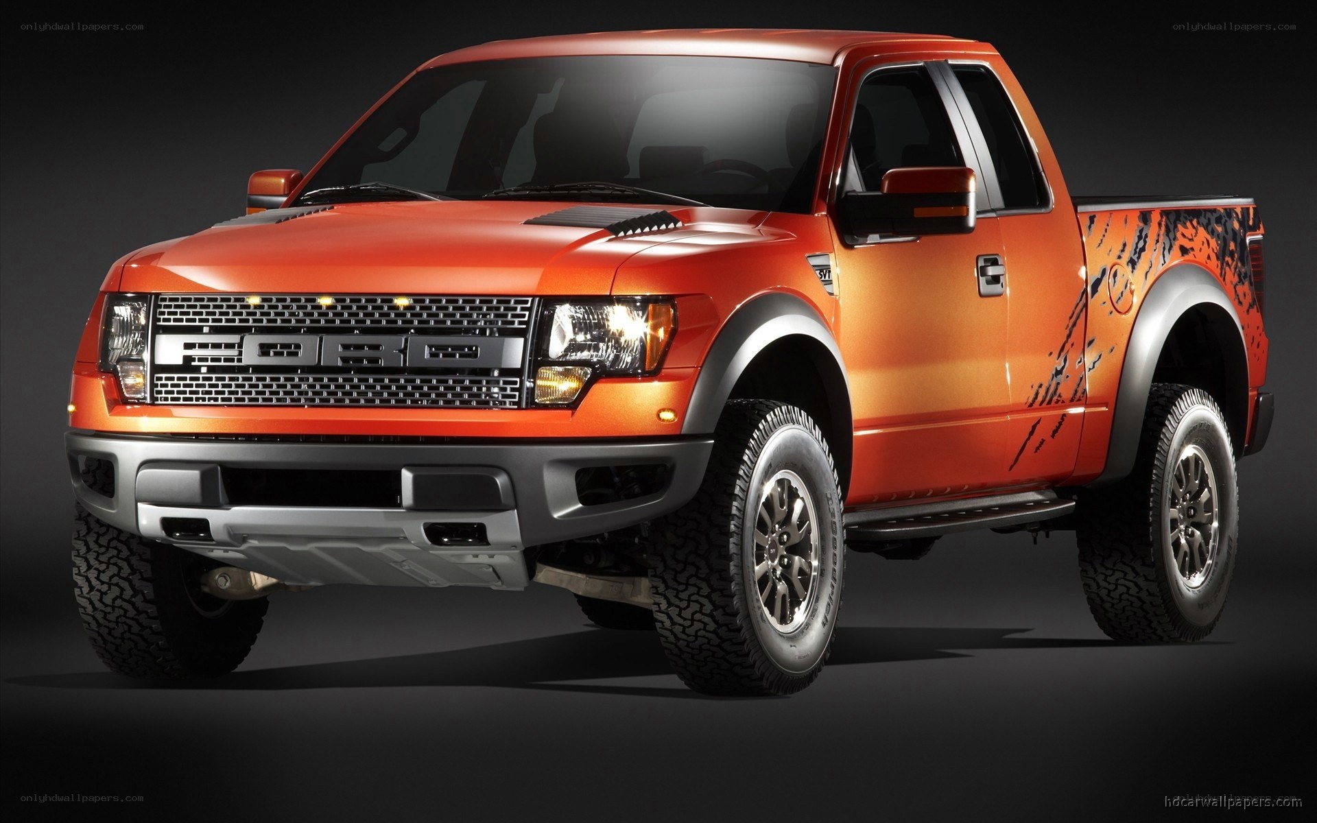 orange Ford Raptor pickup truck