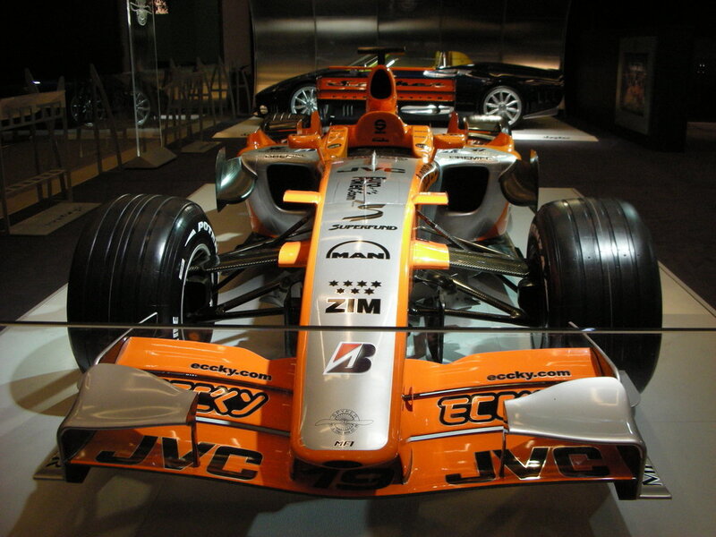 orange formula one car on display