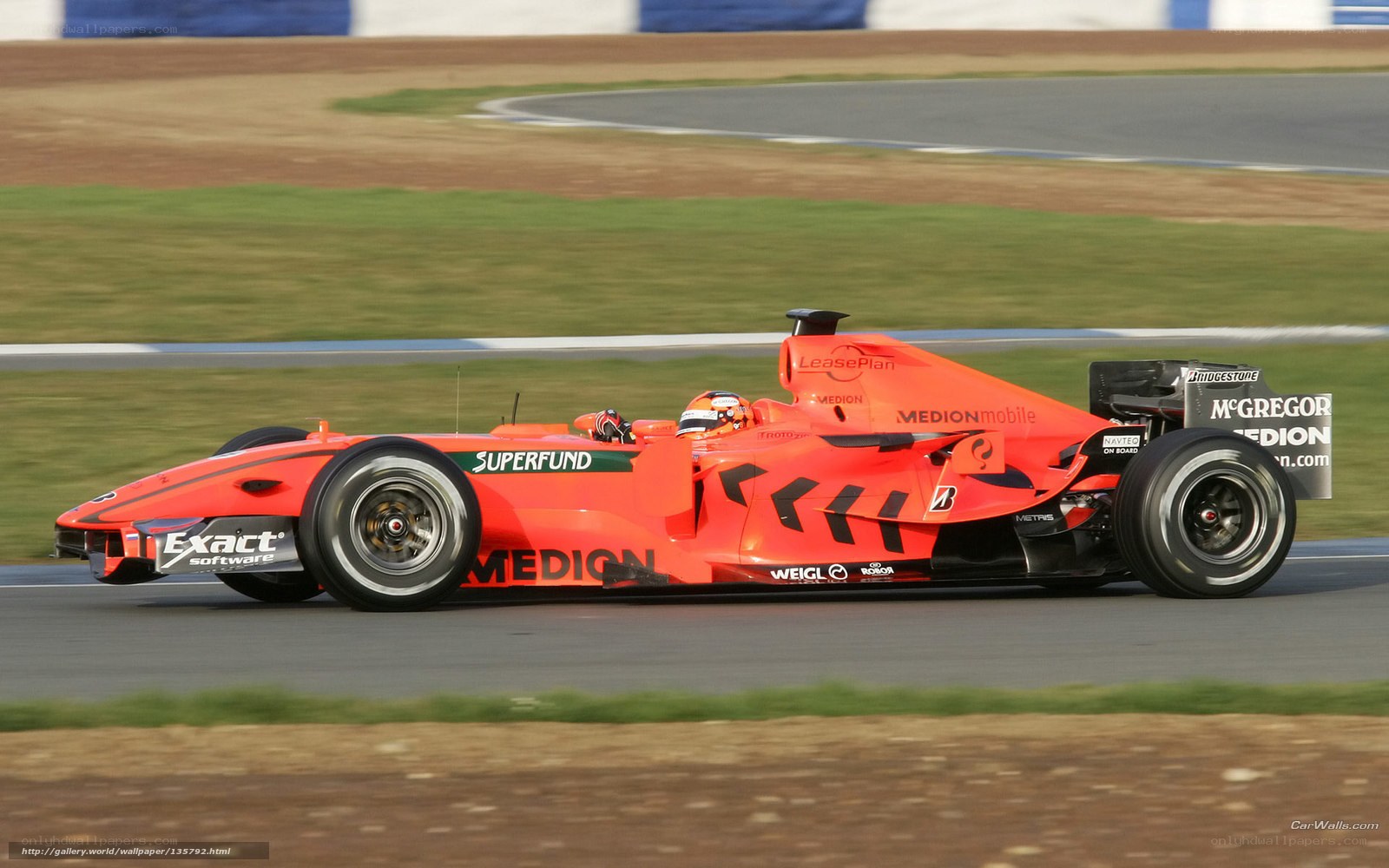 orange formula one car on track