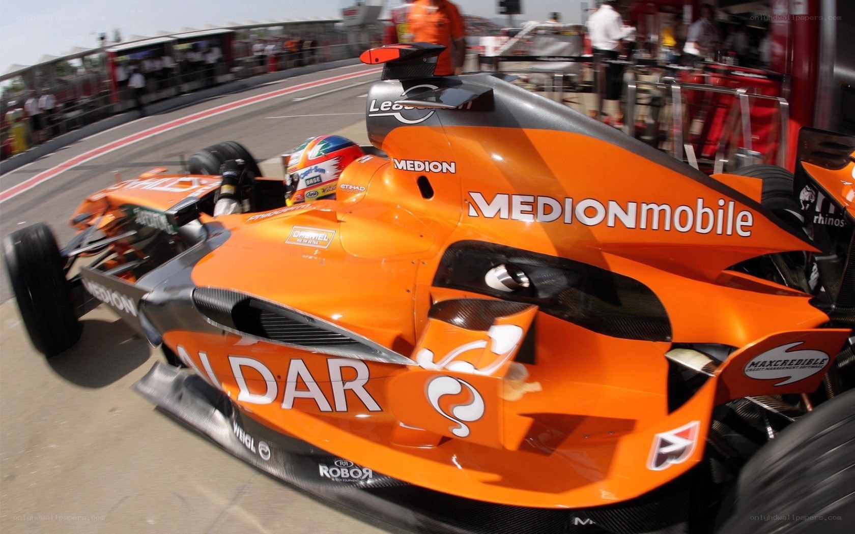 orange formula one car on track