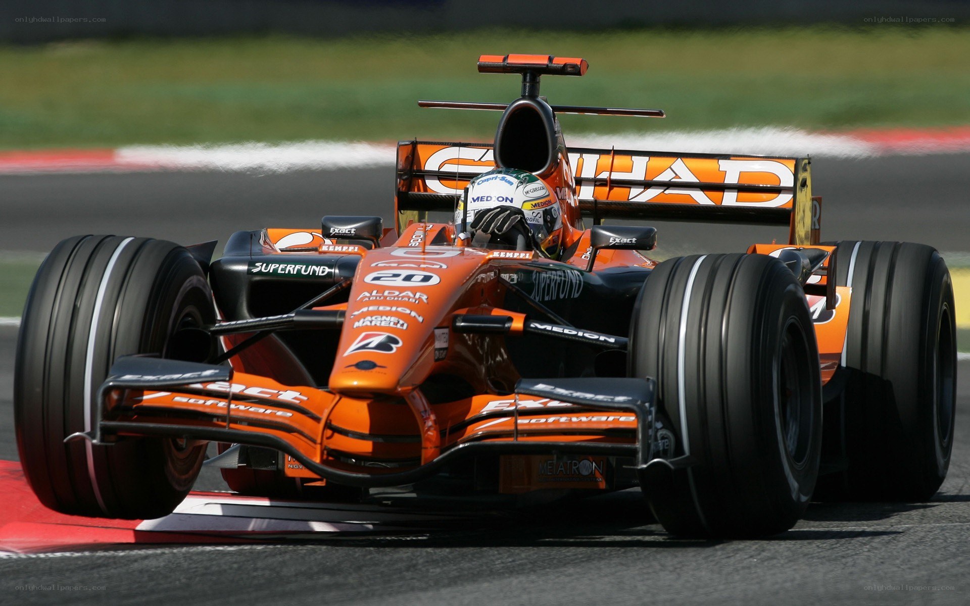 orange formula one car on track