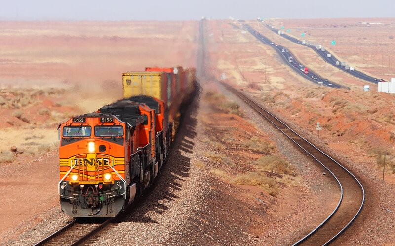 Orange freight train in desert