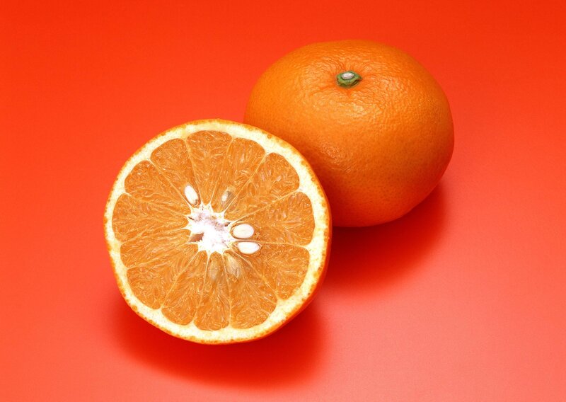Orange fruit on red background