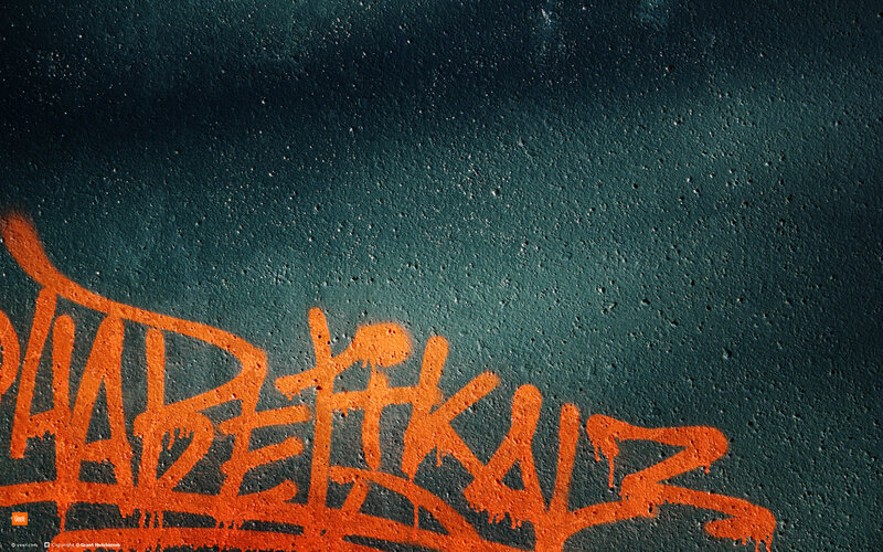 orange graffiti on dark wall