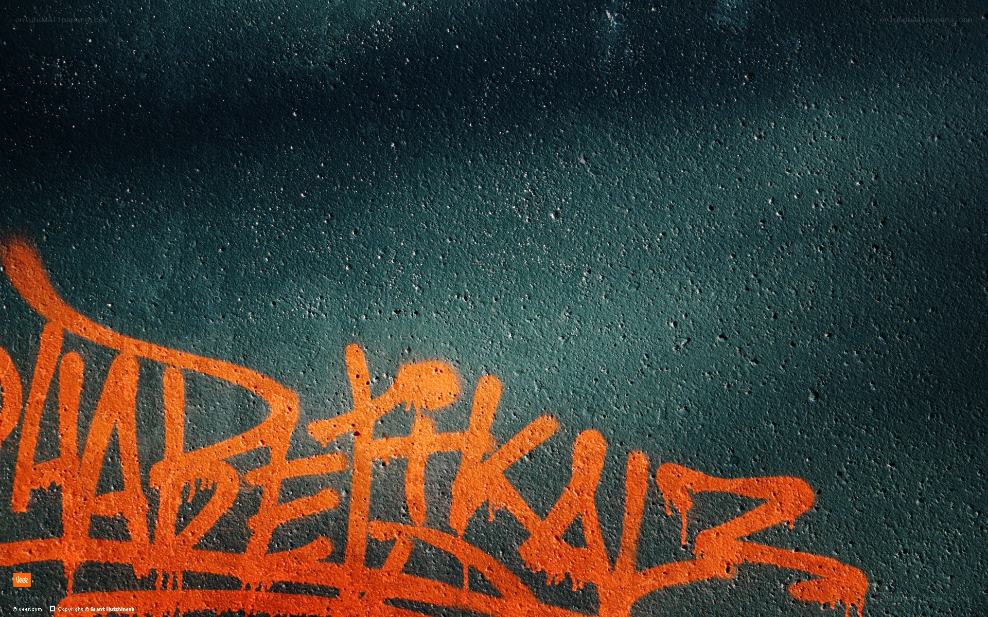orange graffiti on dark wall