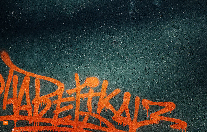 orange graffiti on dark wall