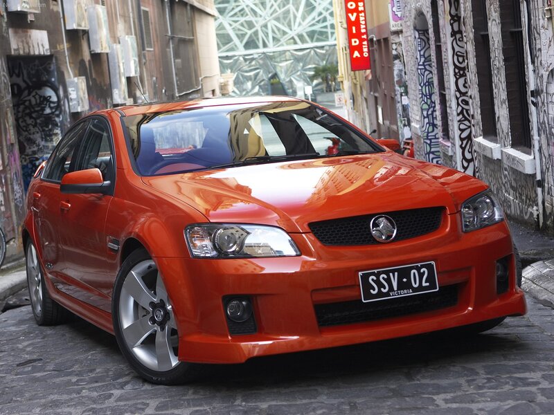 Orange Holden Commodore in alley