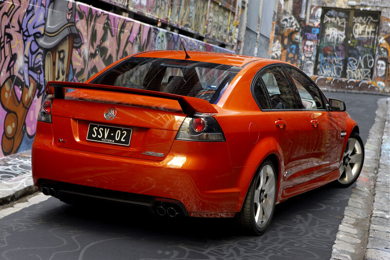Orange Holden Commodore in alley