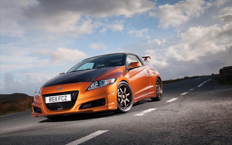 Orange Honda CR-Z on a road