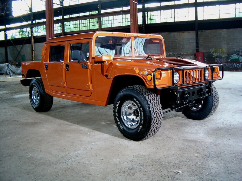 Orange Hummer H1 in warehouse