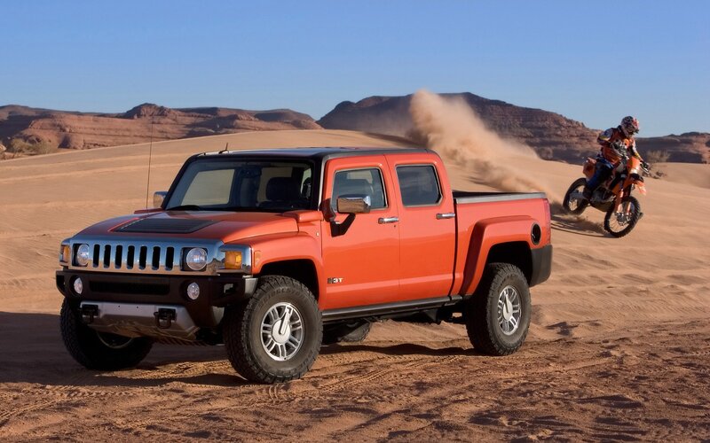 Orange Hummer H3T in desert