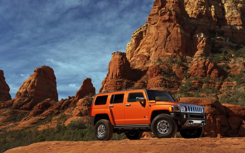 Orange Hummer in desert landscape
