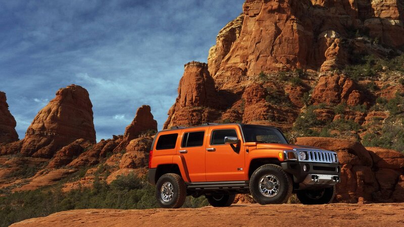 Orange Hummer in desert landscape