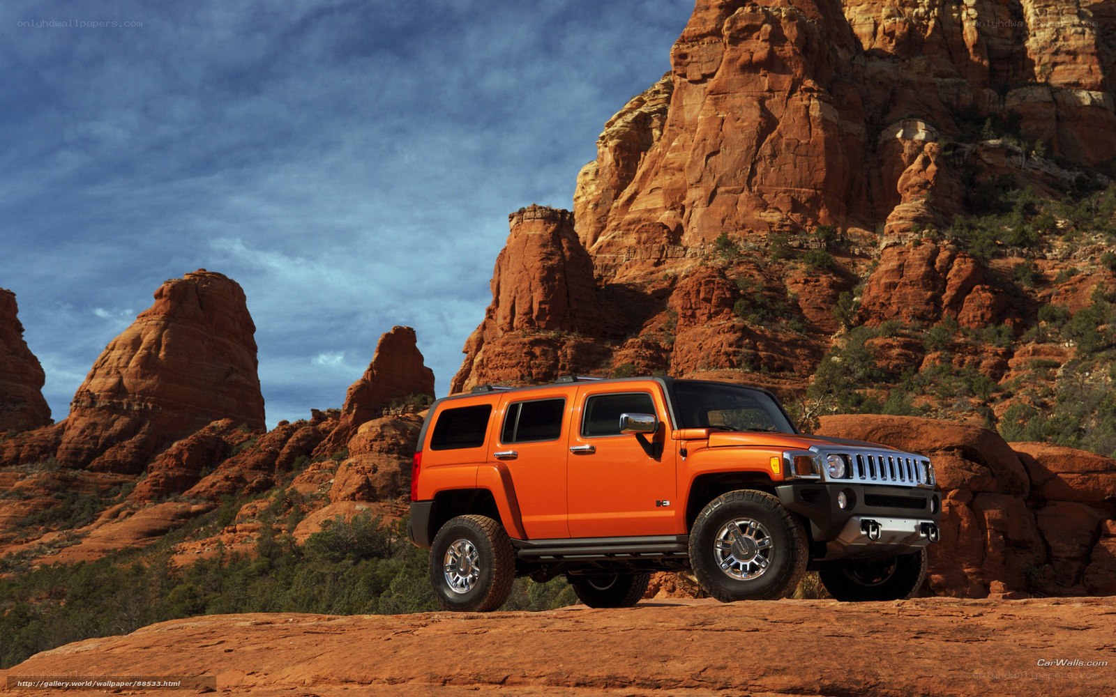 Orange Hummer in desert landscape