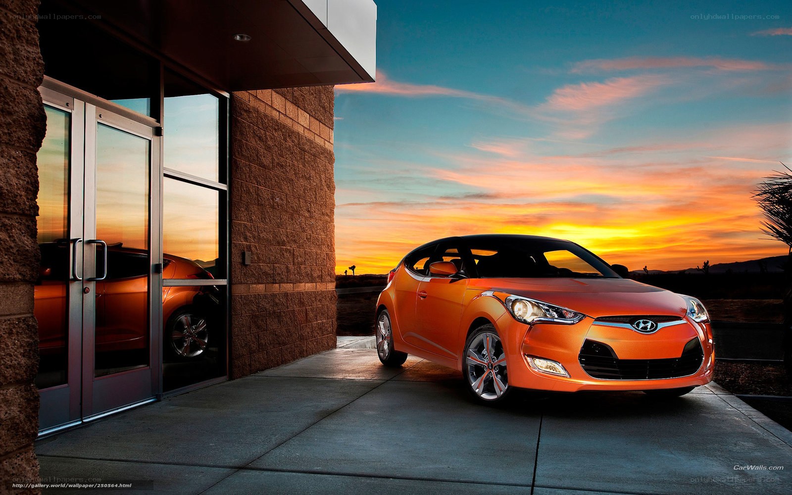 Orange Hyundai Veloster at sunset