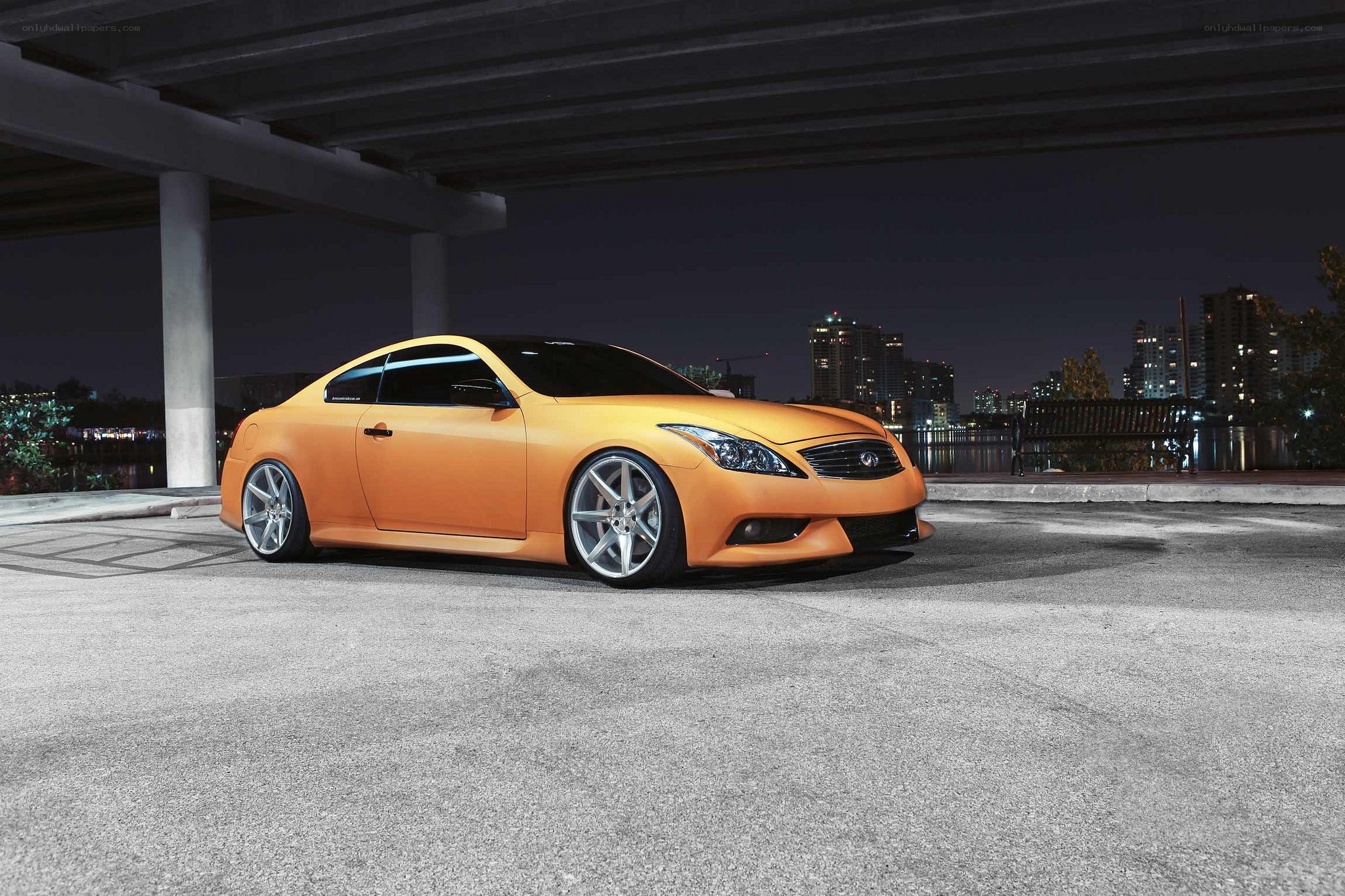 Orange Infiniti G37 under bridge