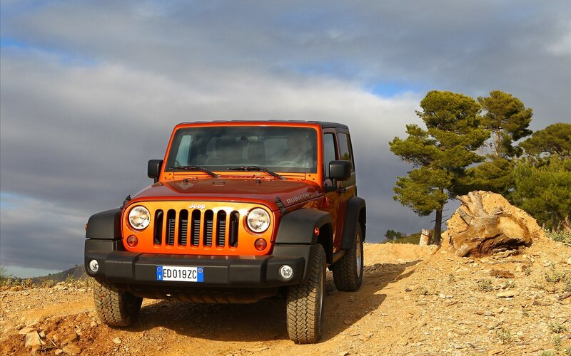 Orange Jeep on a dirt road