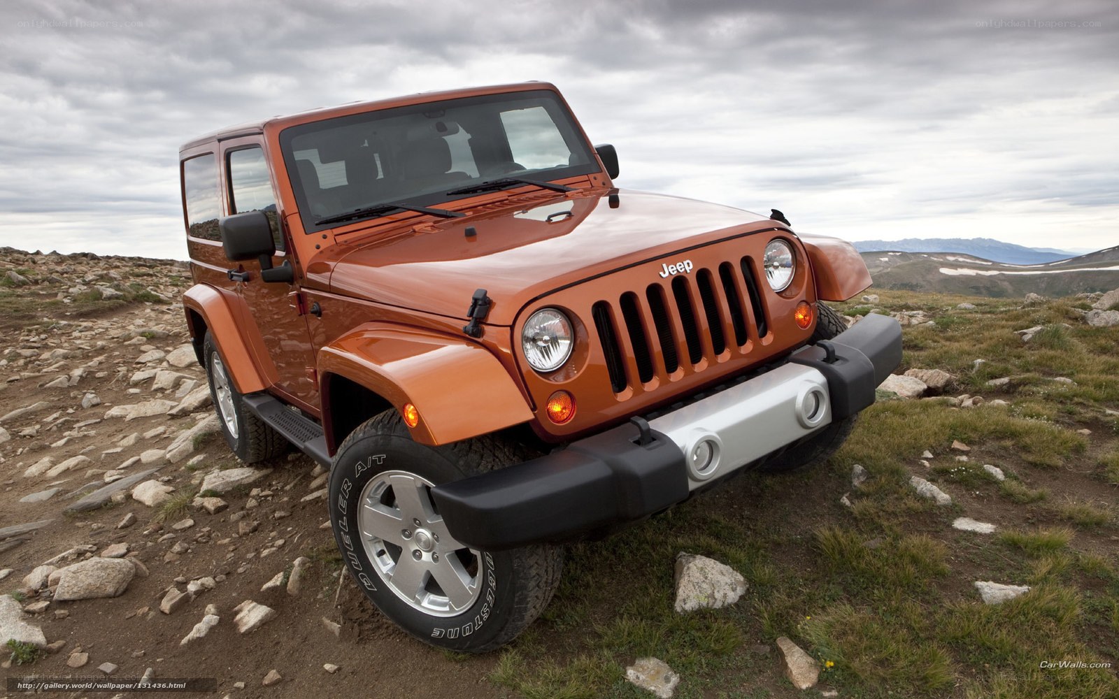 Orange Jeep on a rocky trail