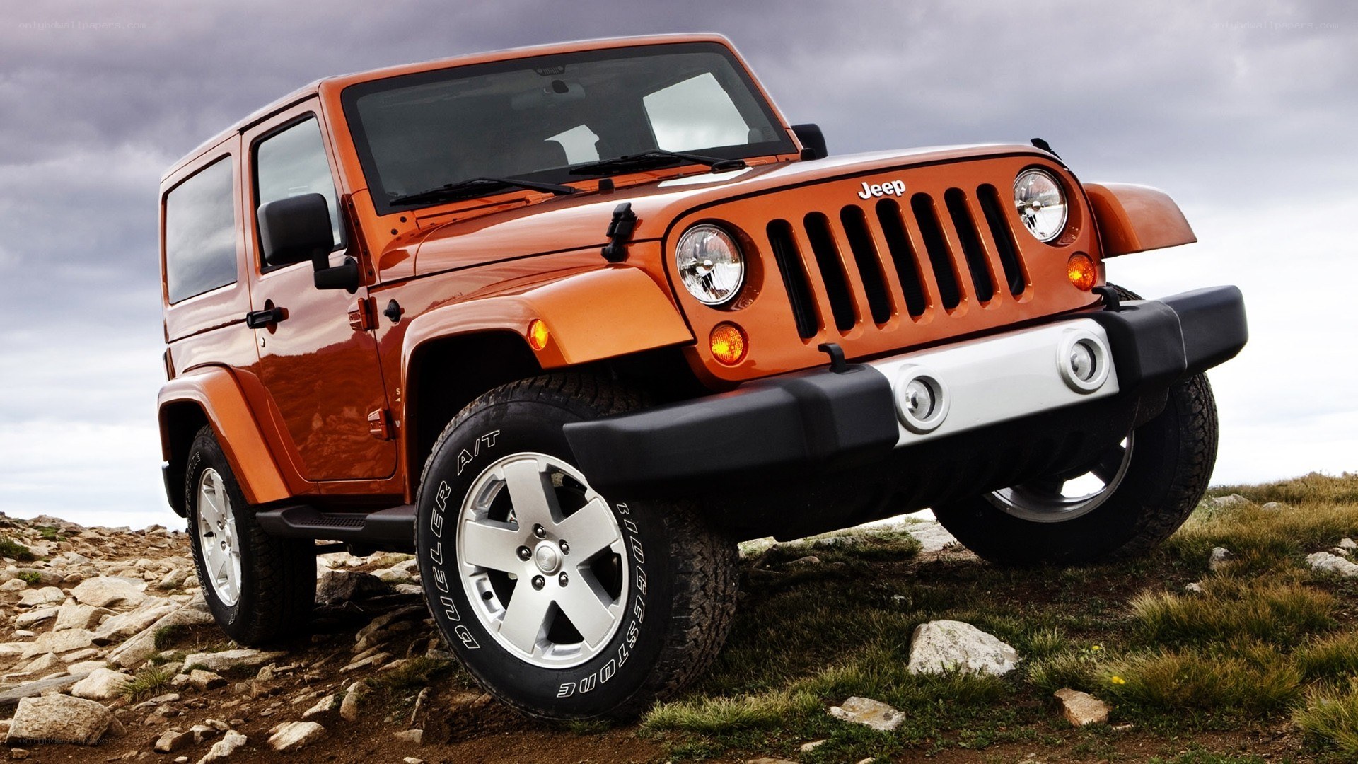 Orange Jeep on rocky terrain