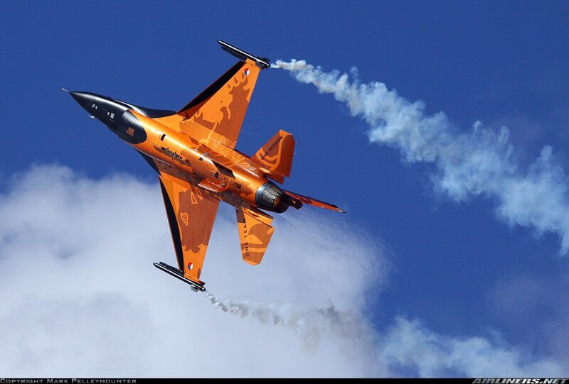 Orange jet performing aerobatics