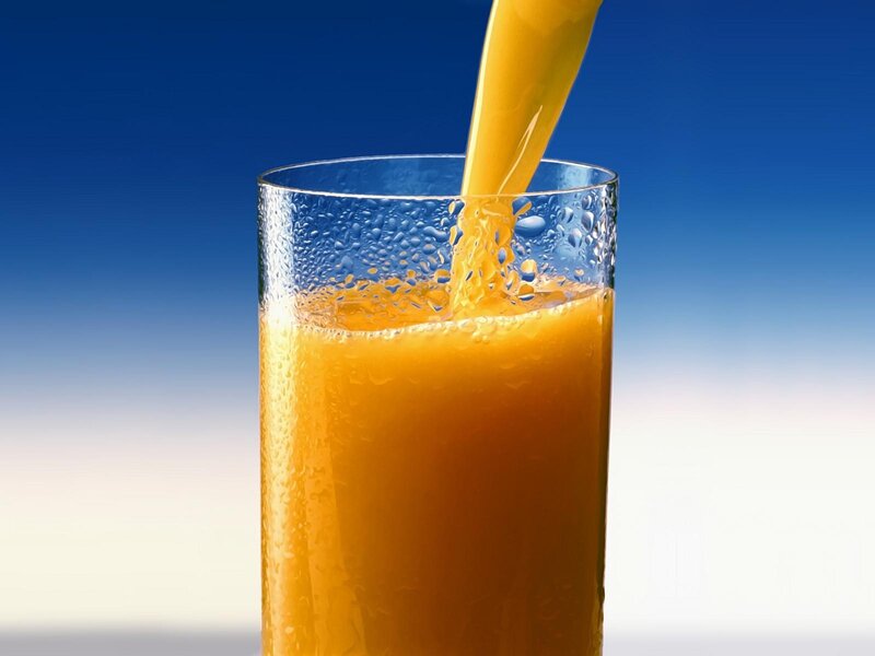 Orange Juice Being Poured — Blue