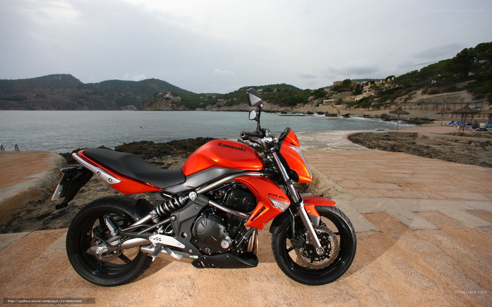 Orange Kawasaki motorcycle on beach