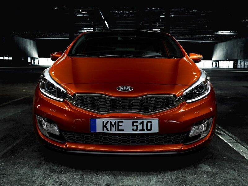Orange Kia car in parking garage