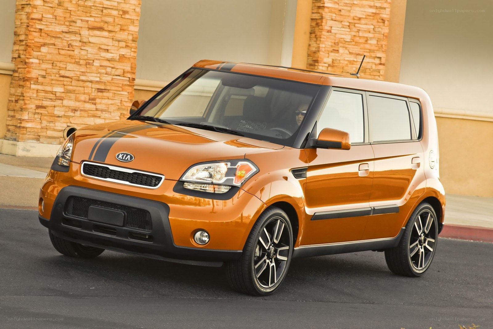 Orange Kia Soul parked outside