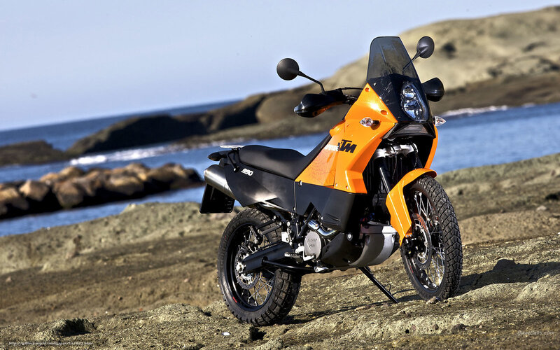 Orange KTM motorcycle on beach