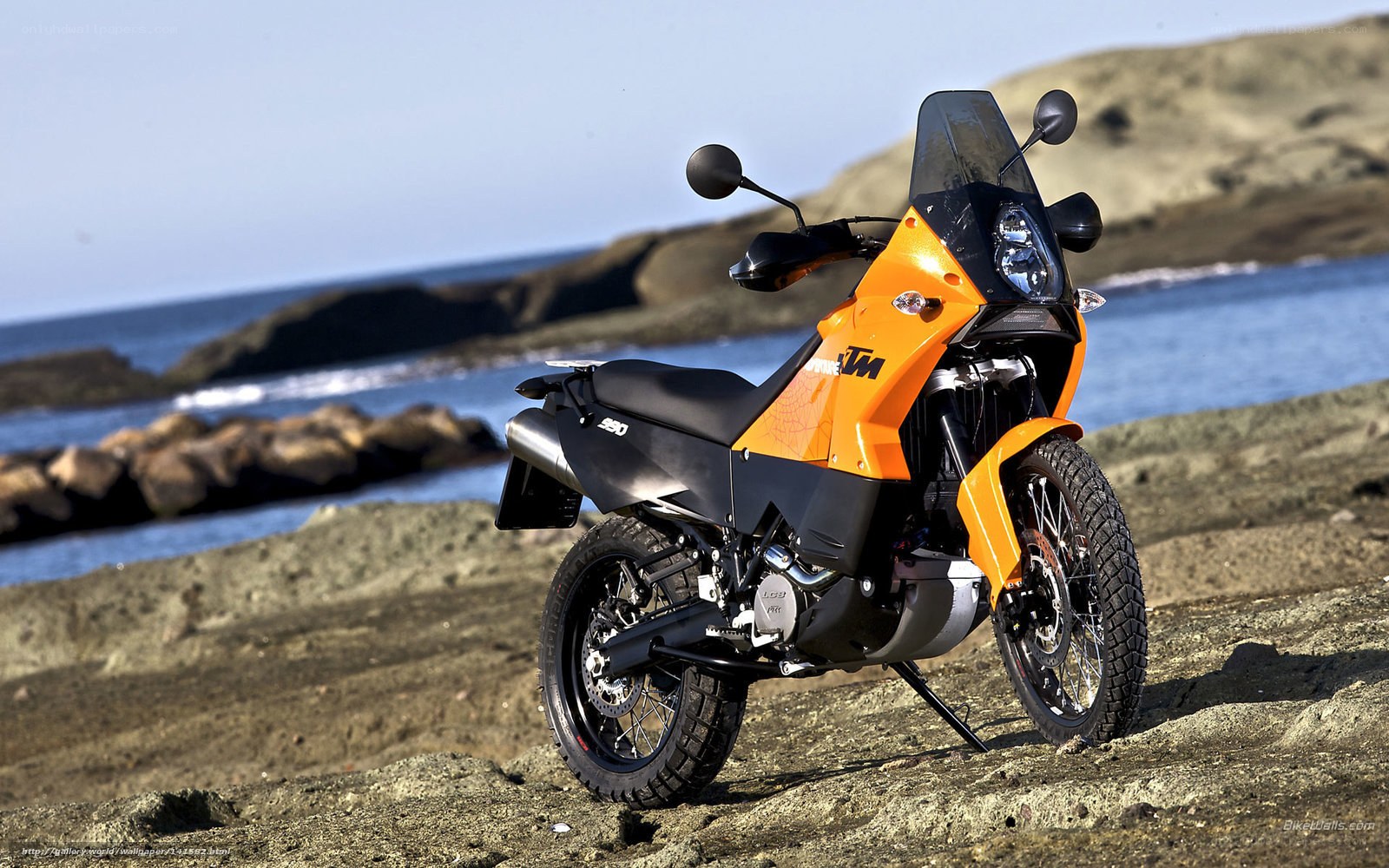 Orange KTM motorcycle on beach