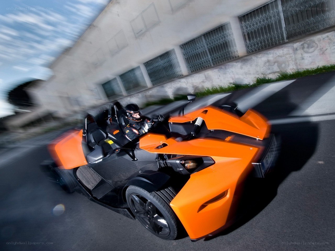 Orange KTM X-Bow in motion