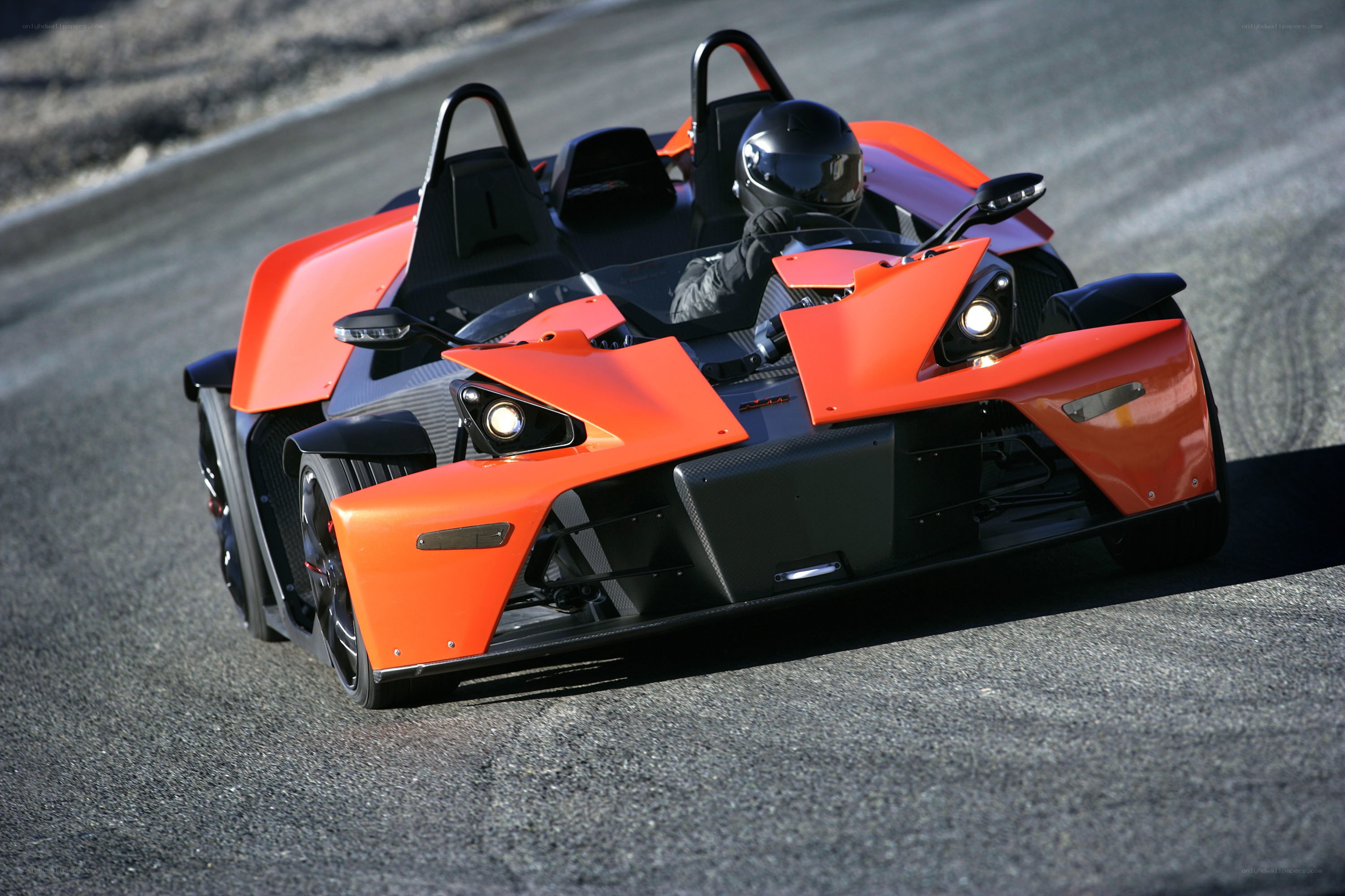 Orange KTM X-Bow on a racetrack