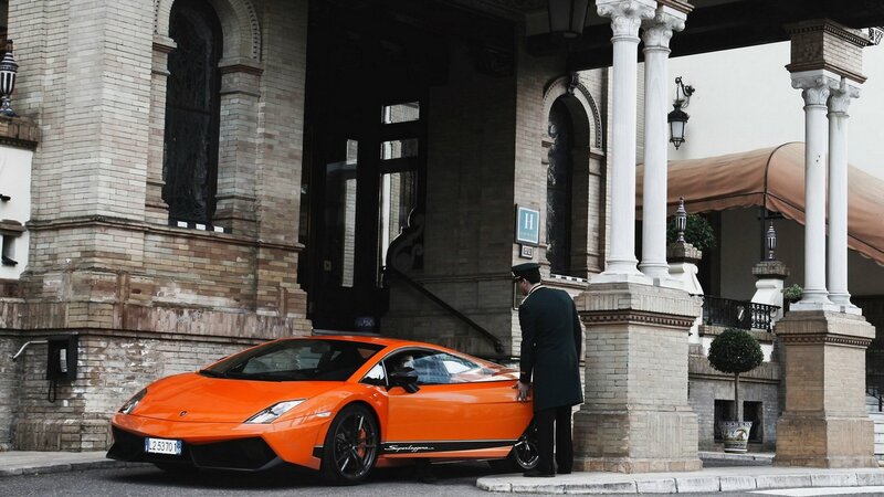 Orange Lamborghini at hotel entrance