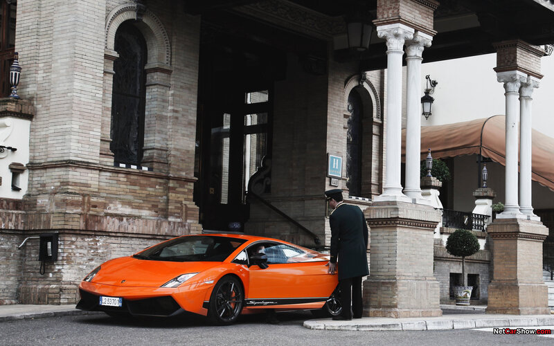 Orange Lamborghini at hotel entrance