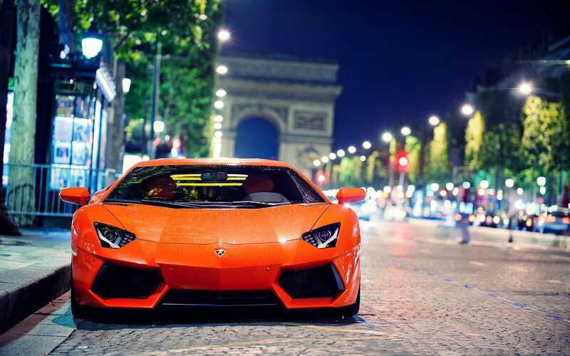 Orange Lamborghini at night in Paris