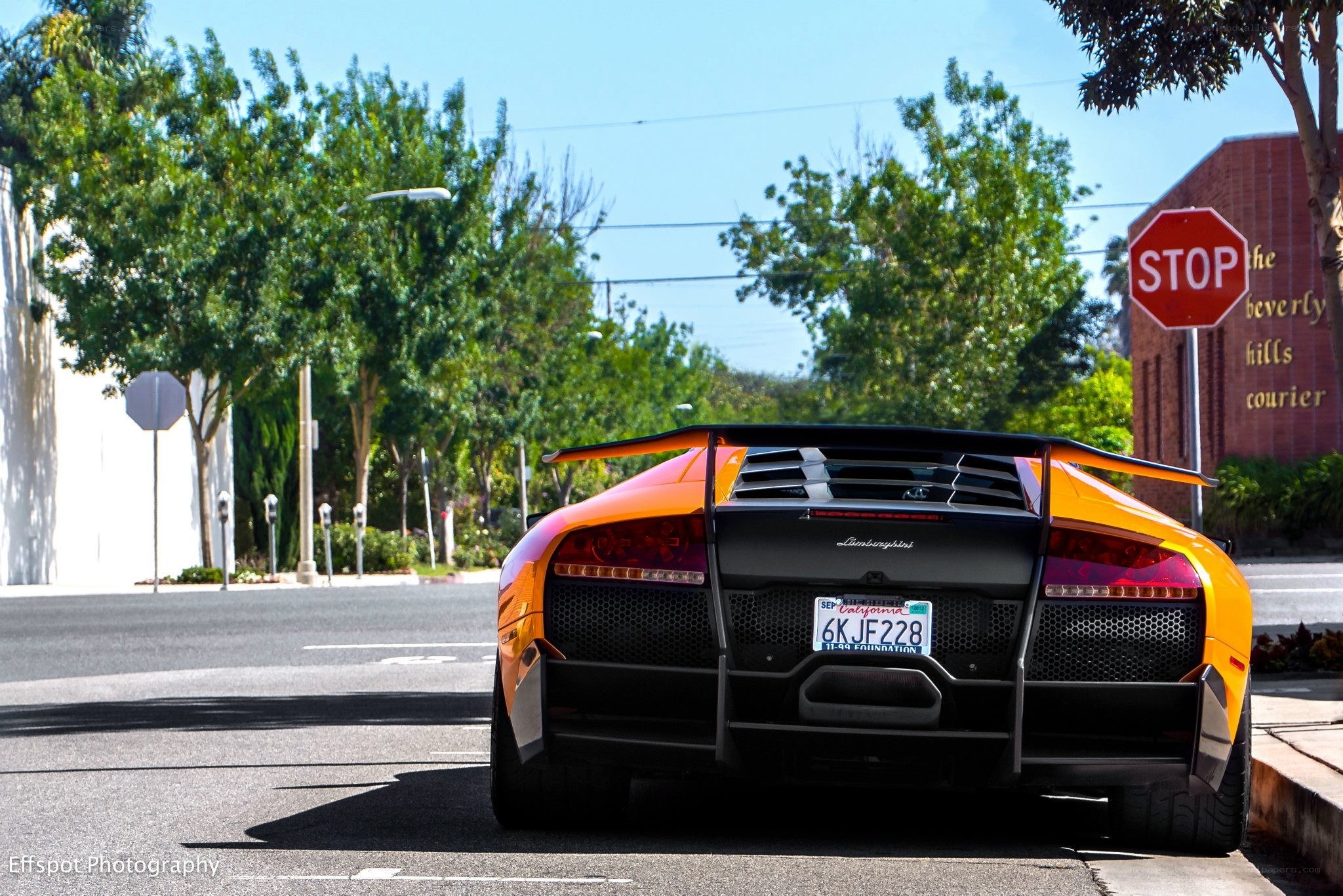 Orange Lamborghini at stop sign