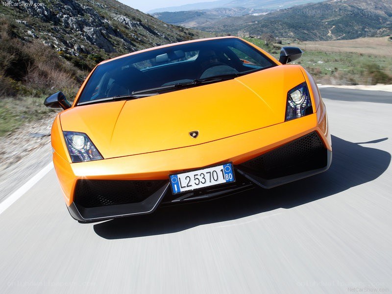 Orange Lamborghini driving on road