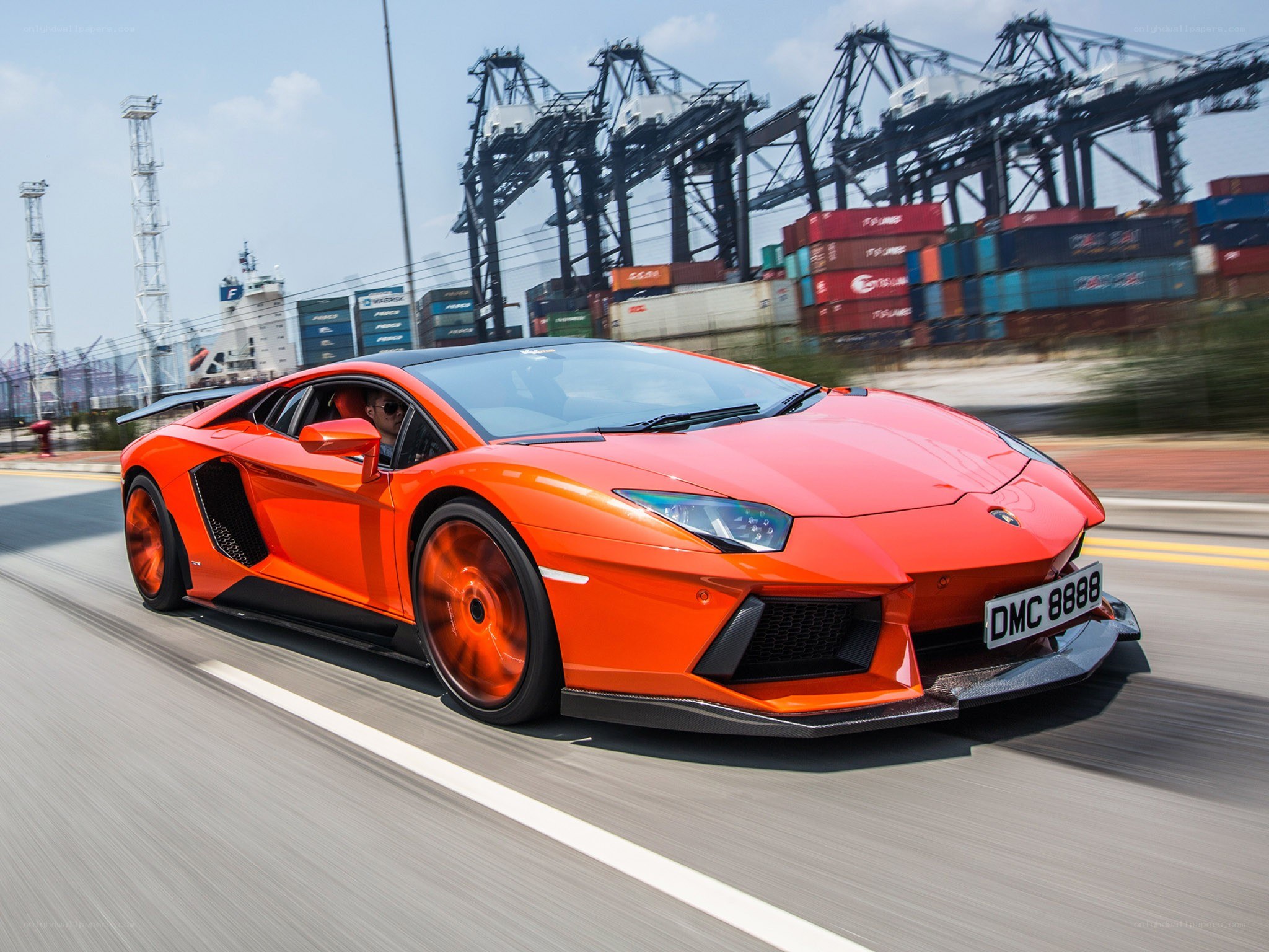 Orange Lamborghini driving on road